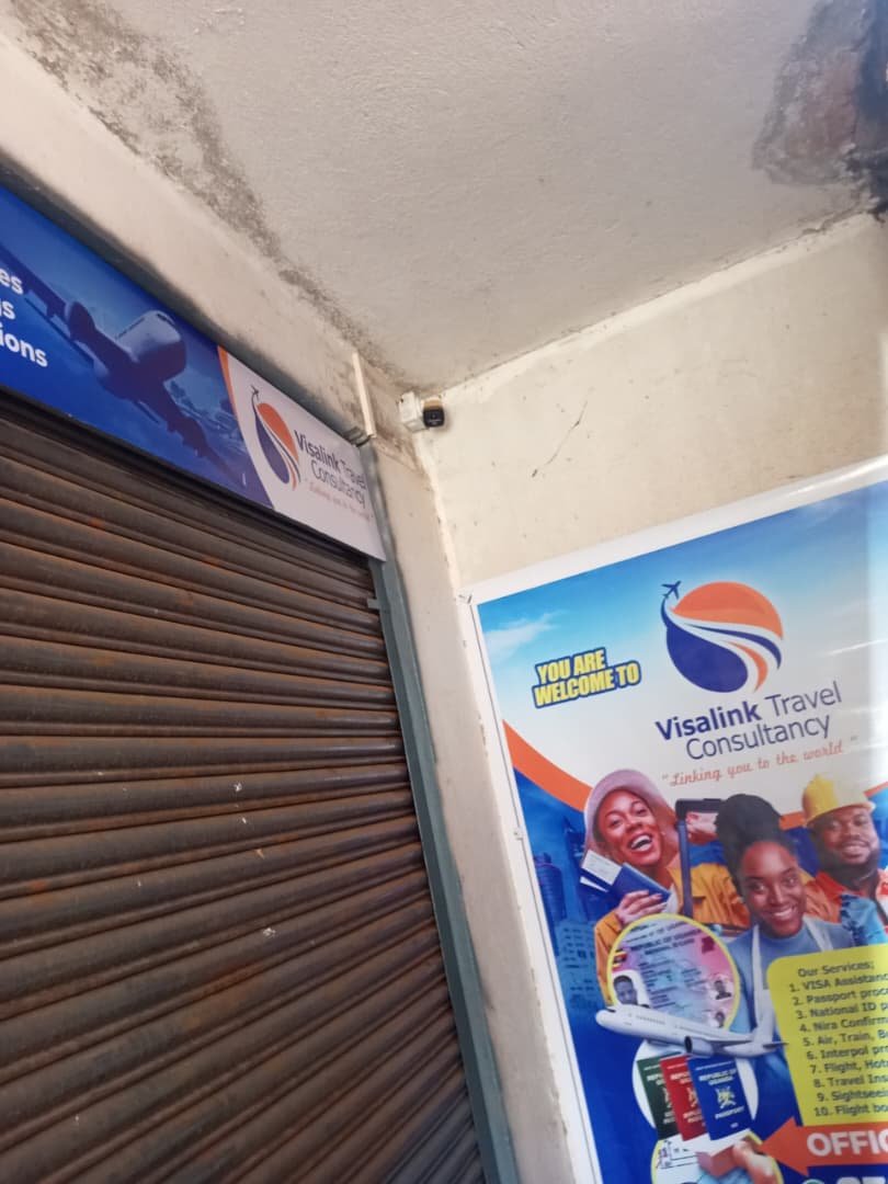 Visa Link Travel Consultancy office entrance poster and signage